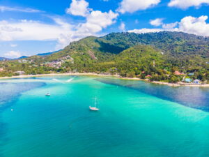 Beautiful aerial view of beach and sea with many tree and white